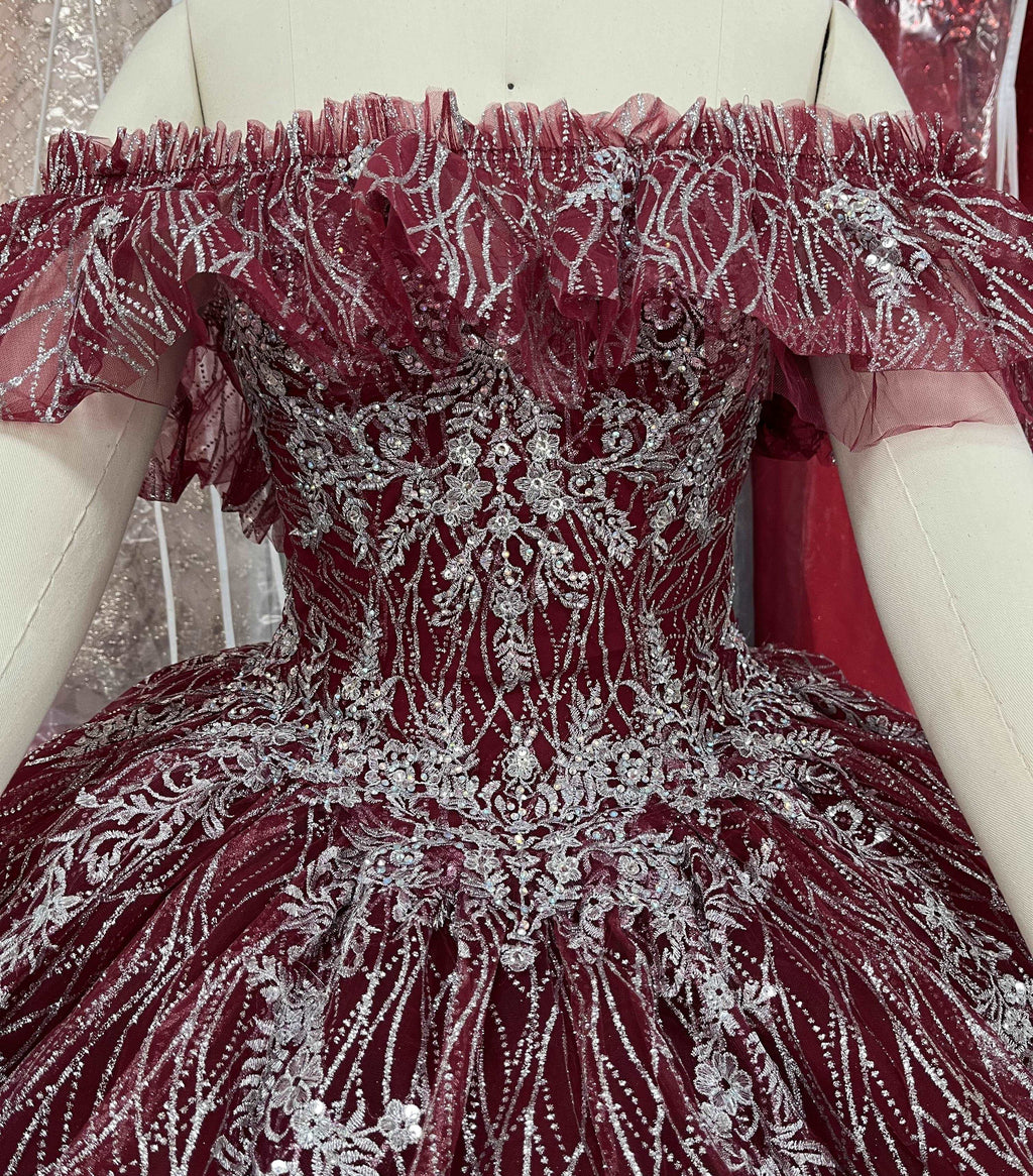 A beautiful gown, off-shoulder, reveals noble air.