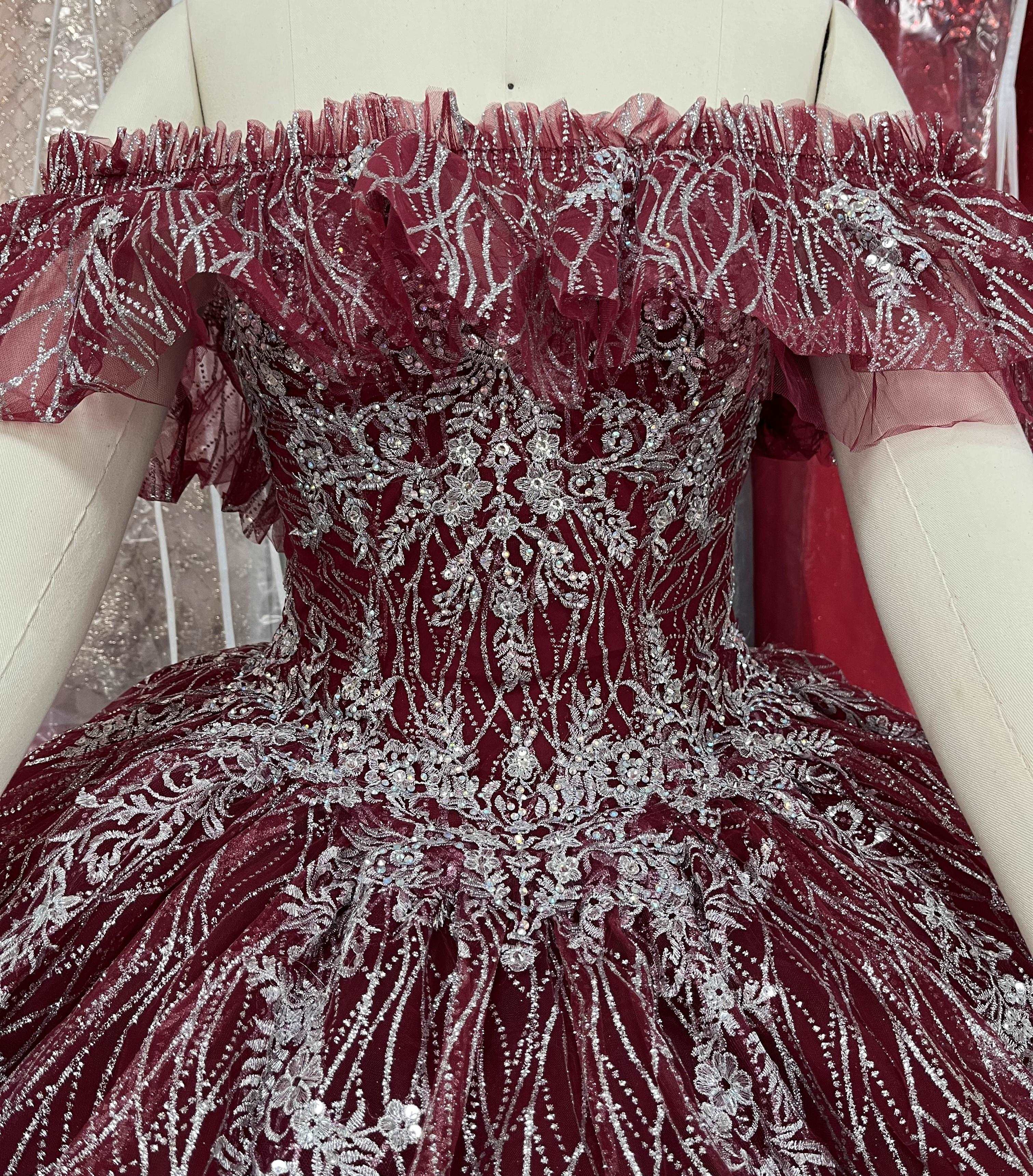 A beautiful gown, off-shoulder, reveals noble air.