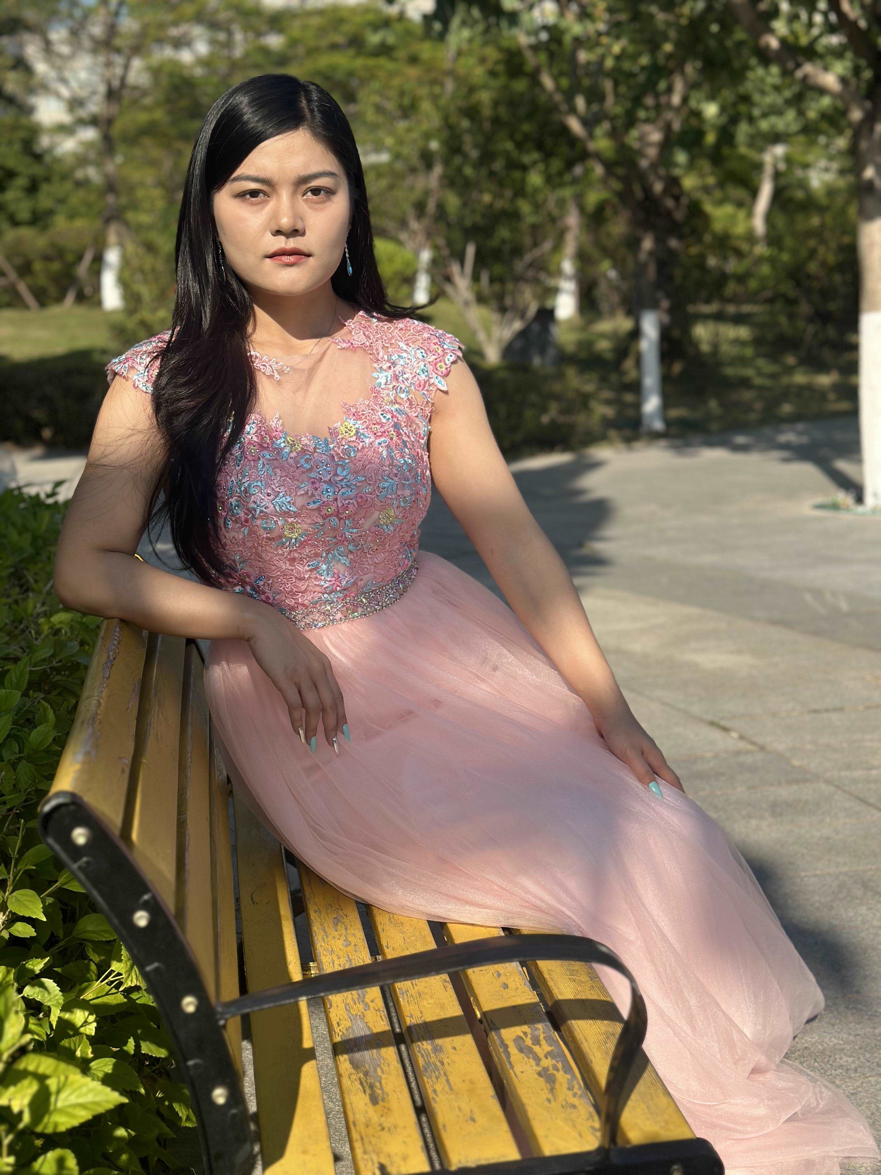 A beautiful gown, off-shoulder, reveals noble air.