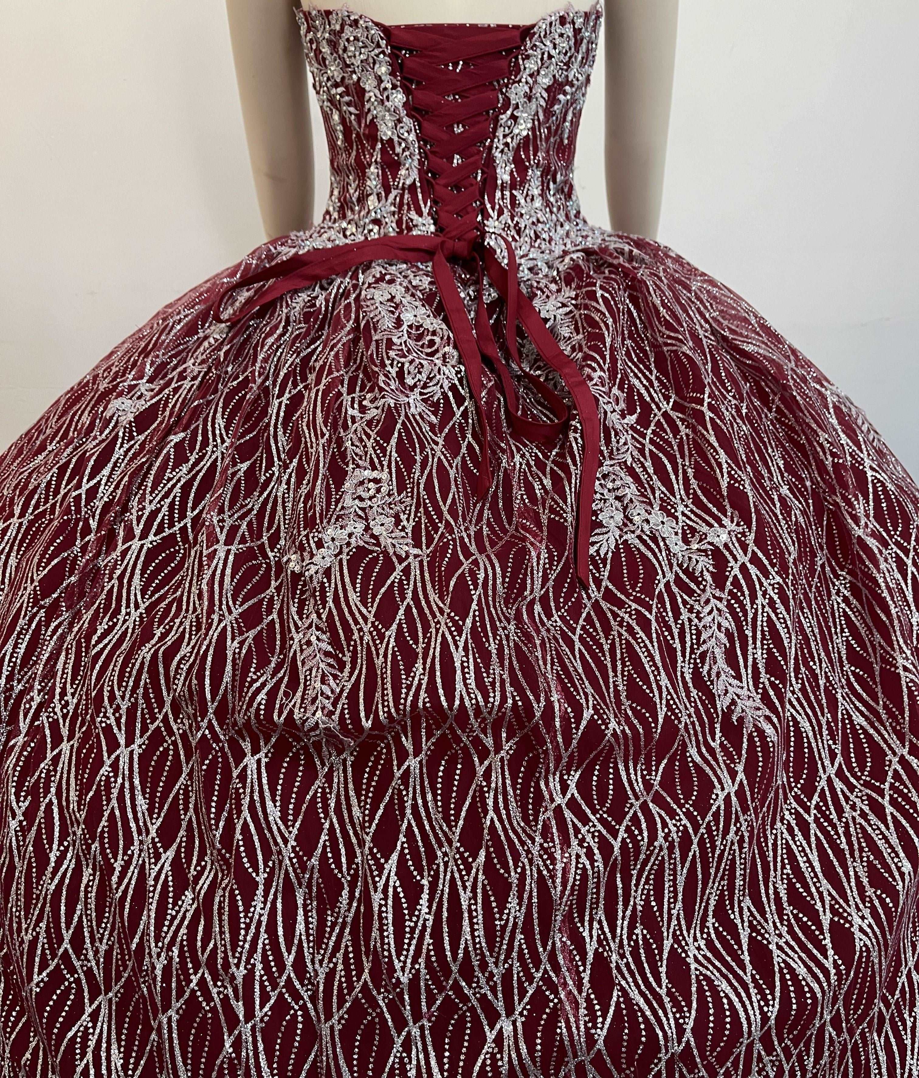 A beautiful gown, off-shoulder, reveals noble air.