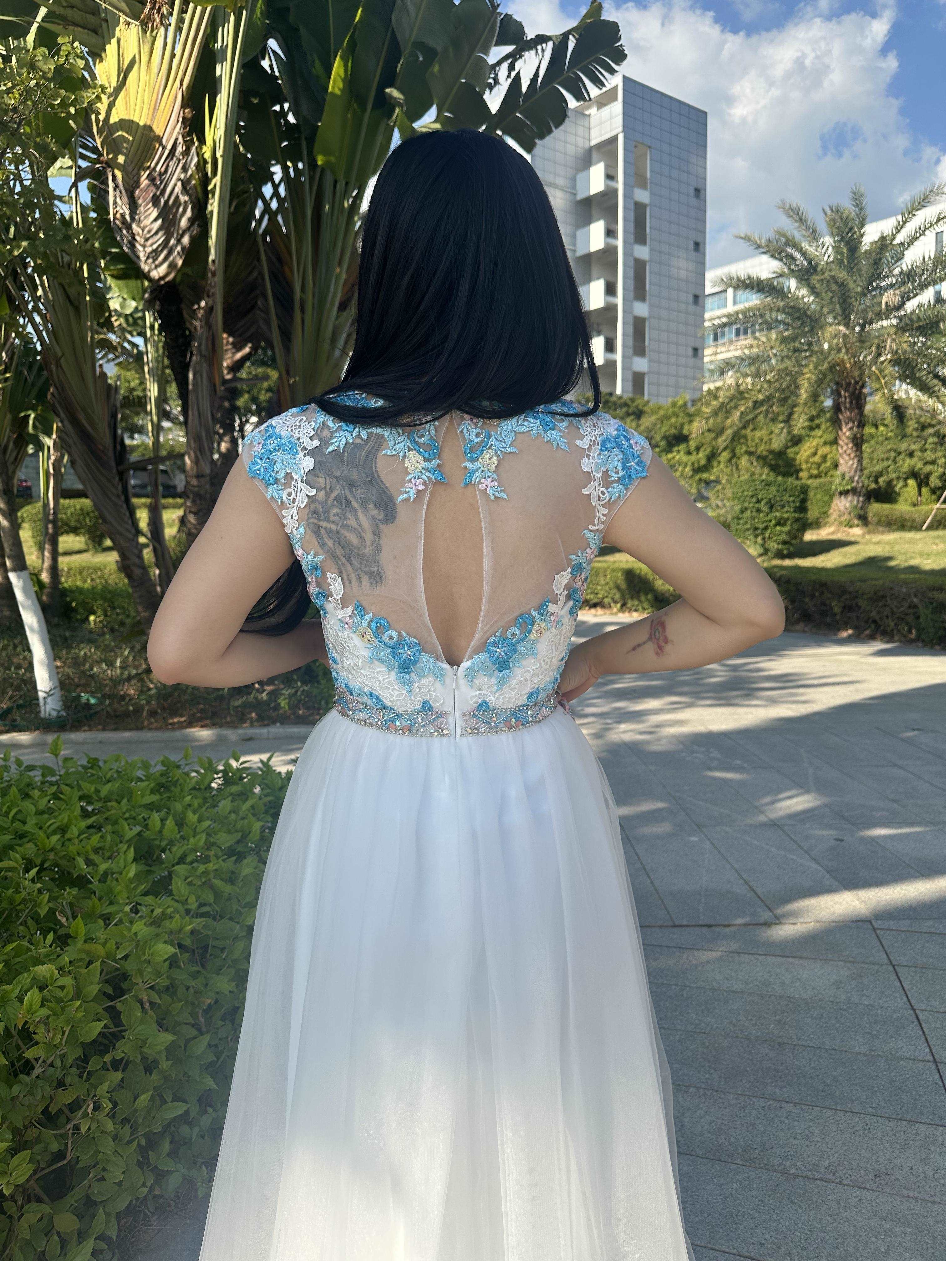 A beautiful gown, off-shoulder, reveals noble air.