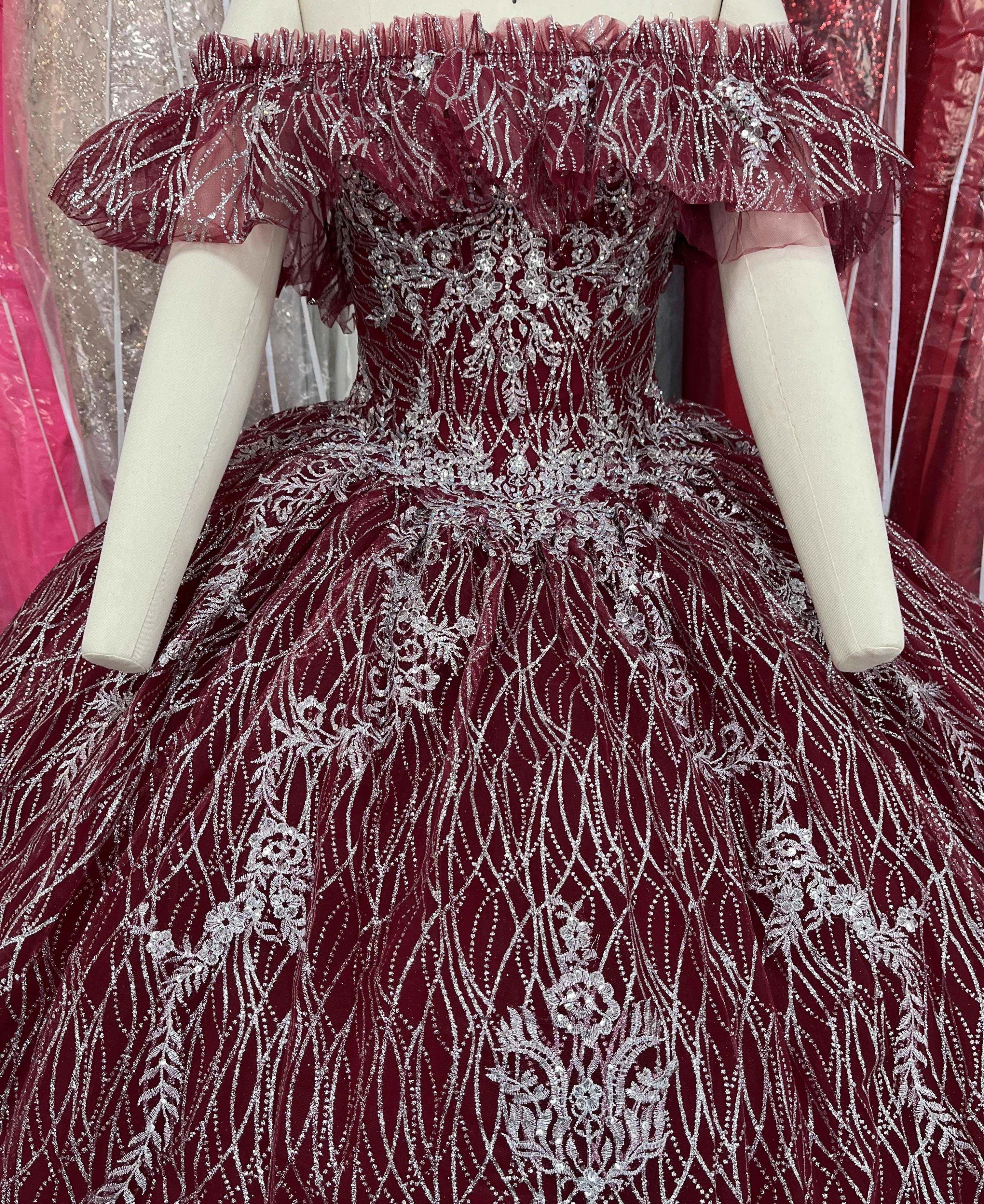 A beautiful gown, off-shoulder, reveals noble air.