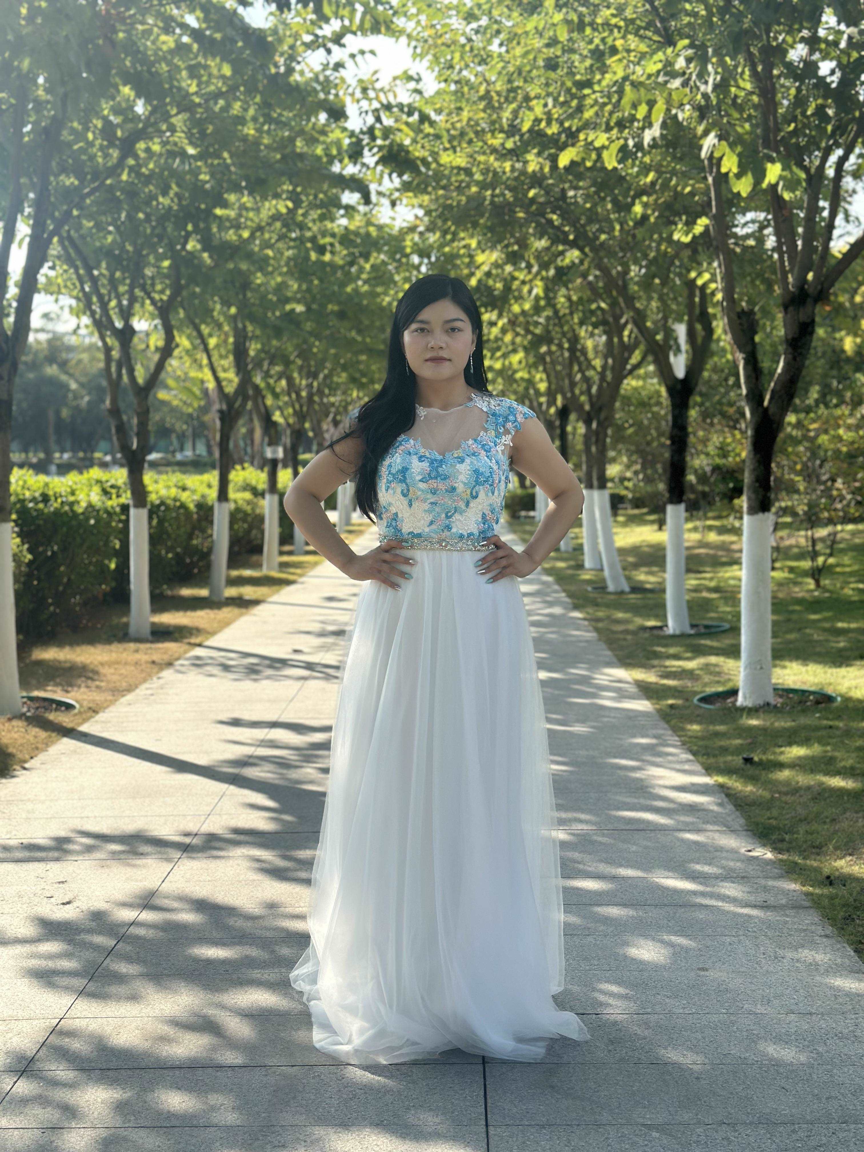 A beautiful gown, off-shoulder, reveals noble air.